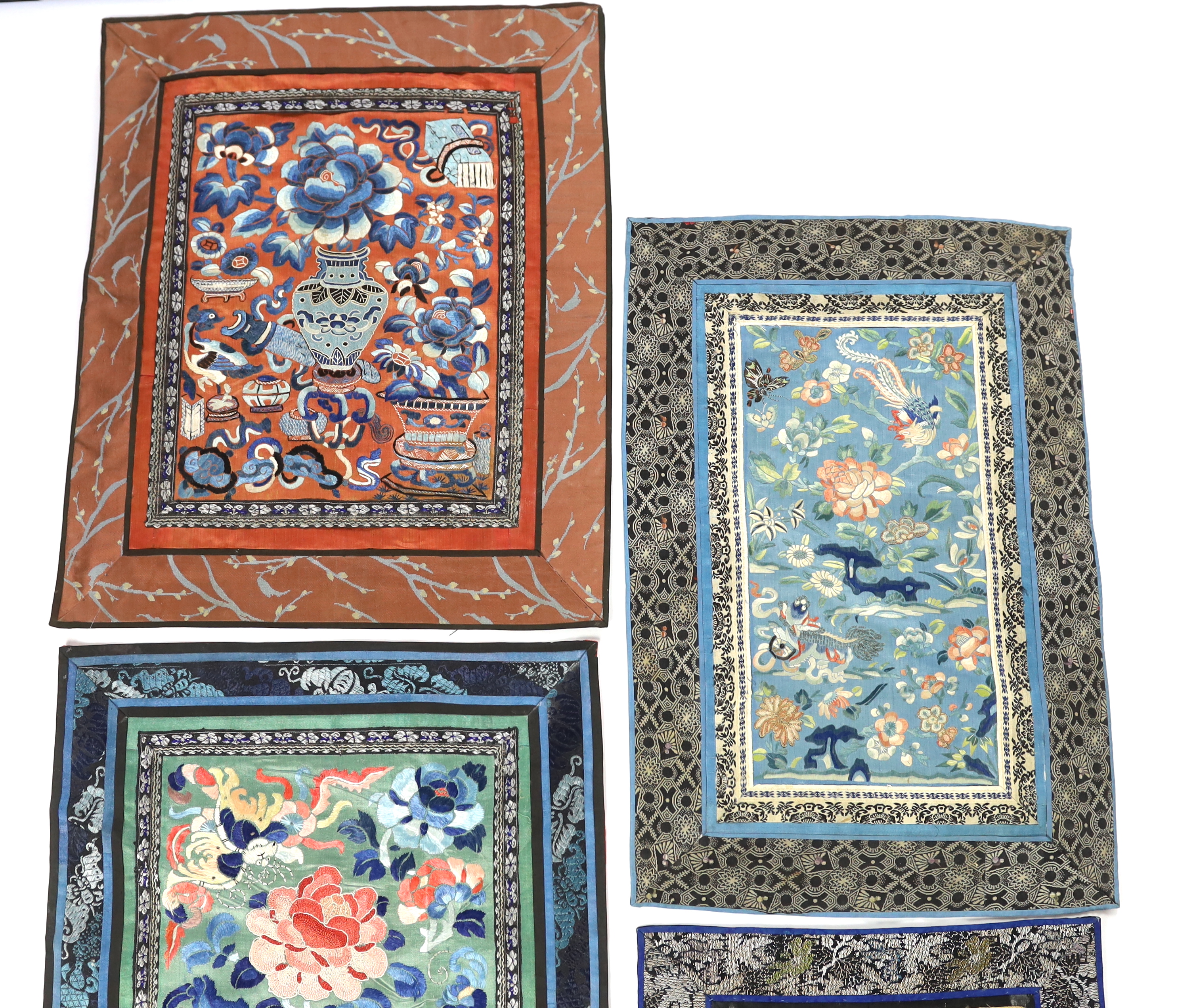 Five Chinese late Qing dynasty silk embroidered panels, two being embroidered with Beijing knot, a pair of metallic embroidered with phoenix sleeve bands, the other embroidered with butterflies and flowers, all five pane